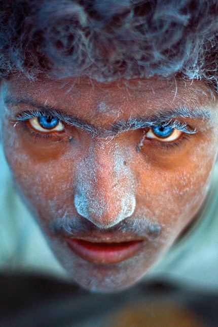 I shot this image at a stone quarry in Rampura, near Bangalore in India, while researching a story on the living and working conditions of labourers employed in the granite industry. I walked into the pit and came upon two boys operating a drill and planting dynamite sticks. Suddenly one of them looked up at me. His eyes were a startling blue and set like sapphires in his dust-covered face. I tried to ask him his name but he just stared and continued to drill. I though the roar of the machine had drowned out my voice, but then his friend told me that he was hearing impaired. The two boys had grown up in the quarry, because their parents worked there too. The constant exposure to high intensity blasts had damaged the blue-eyed boy?s motor-neuron functions. I just had to click because I wanted to show this image to the world as a testimony to the dangers of child labour. Even though it was officially banned in India in 2006, child labour is still a huge problem. Sadly, I never did find out the boy?s name.  Selvaprakash L. India 