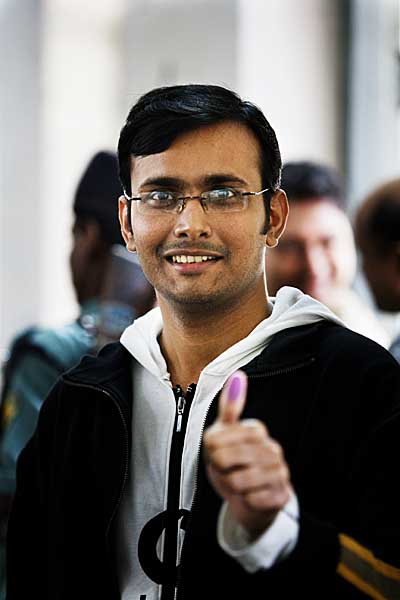 A young voter in Dhanmondi Girls High School in Dhaka, shows the ink stains on his thumb, as evidence of having voted. 29th December 2008. Dhaka. Bangladesh. Shahidul Alam/Drik/Majority World